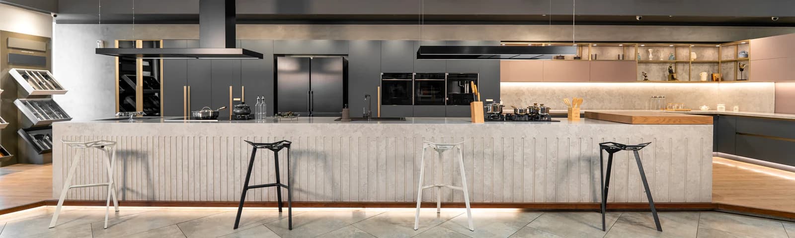 Inside the Trinity and Co. showroom — Häfele kitchen island with built-in hob, twin range hoods, ovens and wine cooler